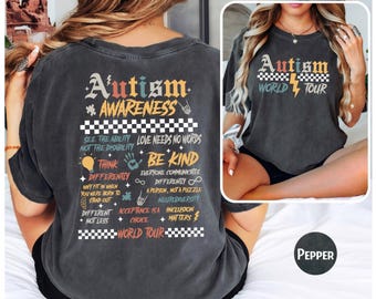 May include: A black t-shirt with a vintage-style design that says "Autism Awareness World Tour" and includes a list of phrases about acceptance and neurodiversity.