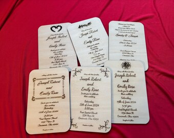 May include: Six laser-cut wooden wedding invitations with different designs. Each invitation features the names "Joseph Robert" and "Emily Rose" with the date and time of the wedding. The invitations are on a red surface.
