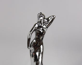 silver-coated resin sculpture, subject “Woman posing”