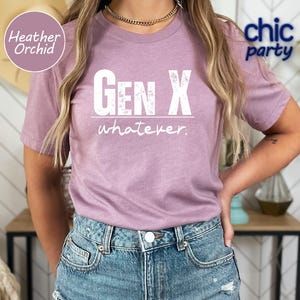 a woman wearing a pink gen x whatever t - shirt