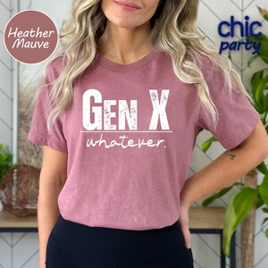 a woman wearing a pink gen x whatever t - shirt
