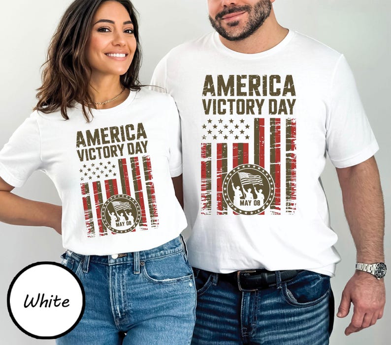 May include: White t-shirts with the text "AMERICA VICTORY DAY" and a distressed American flag design in red, white, and brown. The design includes a circular emblem with figures holding a flag and the date "MAY 08".