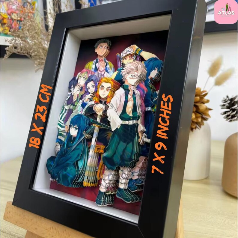 May include: A framed 3D artwork featuring a group of anime characters. The black frame holds a layered paper design with vibrant colors. The artwork measures 7 x 9 inches (18 x 23 cm).