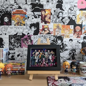 May include: A framed artwork featuring a group of anime characters, displayed on a small wooden easel. The background is a wall covered in black and white manga panels. Anime figurines and manga volumes are also visible.