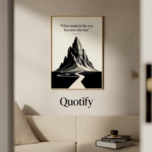 May include: A black and white illustration of a mountain with a winding road leading to the peak. The quote "What stands in the way, becomes the way." is printed below the image. The word "Quotify" is printed below the quote.