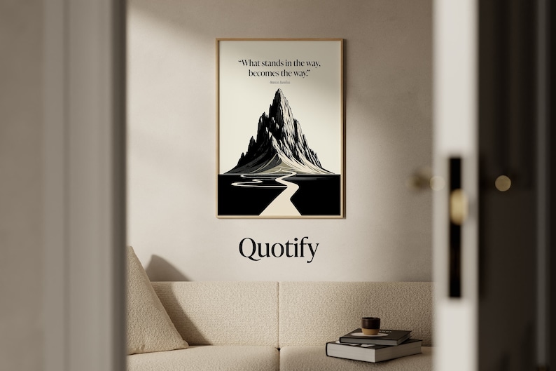 May include: A black and white illustration of a mountain with a winding road leading to the peak. The quote "What stands in the way, becomes the way." is printed below the image. The word "Quotify" is printed below the quote.