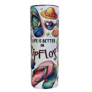 May include: White tumbler with a colorful beach-themed design. The tumbler features illustrations of flip-flops, a sun hat, heart-shaped sunglasses, and seashells. Text on the tumbler reads "LIFE IS BETTER IN Flip FLOPS."