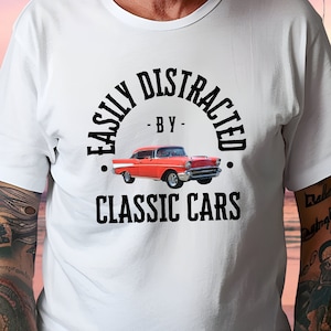 May include: White t-shirt with a black graphic that says "Easily Distracted by Classic Cars" and features a red classic car.