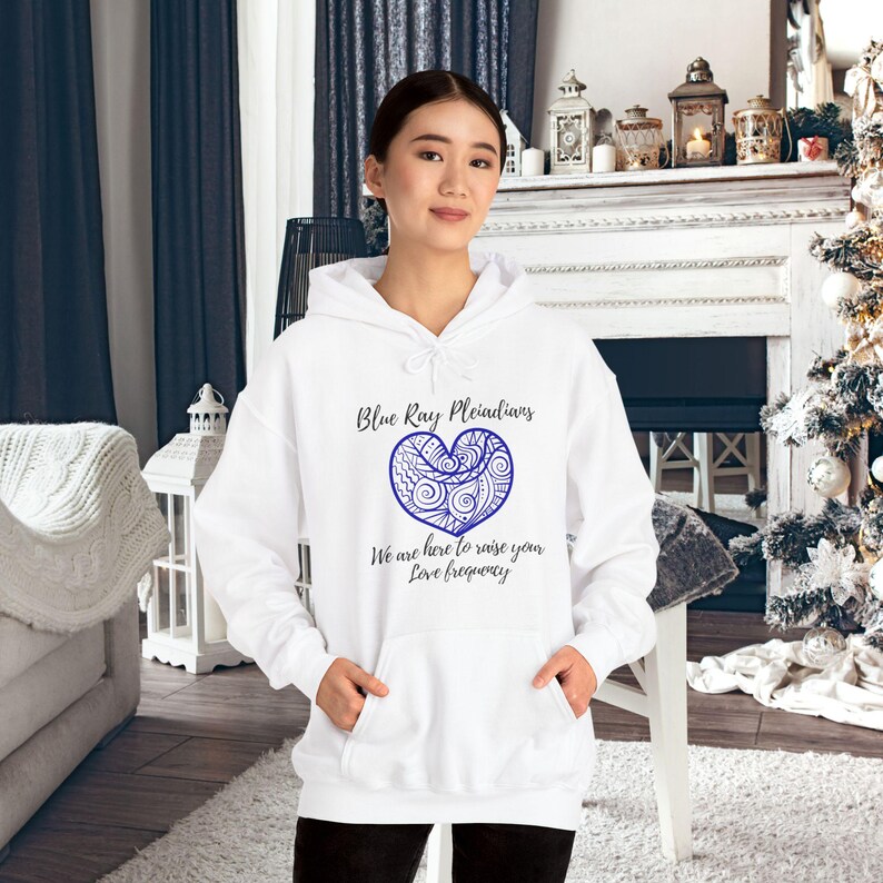 May include: White hoodie with a blue heart design and the text 'Blue Ray Pleiadians' and 'We are here to raise your Love frequency'.