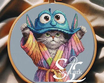 Whimsical cross stitch pattern of an unimpressed cat in a rainbow robe and humorous hat ideal project for cat lovers, digital PDF embroidery