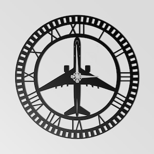May include: Black metal wall clock featuring a silhouette of an airplane within a circular frame. The clock face has Roman numerals and a decorative outer edge. The clock hands are silver.