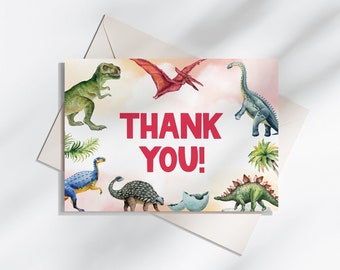 May include: A pink thank you card with a watercolor illustration of dinosaurs. The card says "THANK YOU!" in red letters.