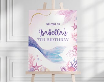May include: A welcome sign for a 7th birthday party with a mermaid tail, seashells, and starfish. The sign says "Welcome to Isabella's 7th Birthday".
