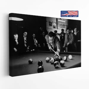 May include: A black and white canvas print depicting a group of men in suits gathered around a pool table. One man is leaning over the table to take a shot with a pool cue, while others watch from the background. The image includes a small flag icon.