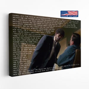 May include: A rectangular canvas wall art print featuring a scene from the film Pulp Fiction with Jules Winnfield in a dark suit standing over another person. The text of the Ezekiel 25:17 monologue is printed in white over the image.