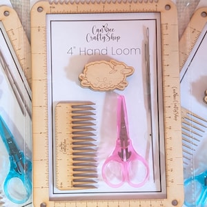 May include: Multiple 4" hand loom kits are shown, each including a wooden frame, comb, scissors, and a sheep charm. The kits are packaged on white cards with the text "Can Bee Crafty Shop" and "4" Hand Loom". The scissors are either pink or blue.