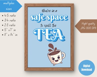 May include: A framed print with a light blue background and a wooden frame. The print features the text "You're in a safe space to spill the TEA" in white and blue. A cartoon coffee cup is at the bottom. The print is available in multiple sizes, including 5" x 7" and 11" x 14".