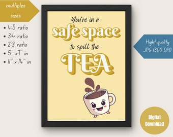 May include: Framed art print with a yellow background and black frame. The text reads "You're in a safe space to spill the TEA" with a cartoon coffee cup illustration. Available in multiple sizes, including 5" x 7" and 11" x 14".