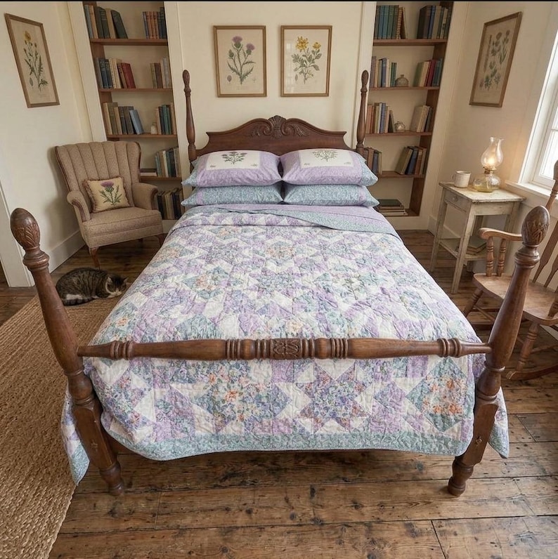 May include: A wooden four-poster bed frame with a carved headboard, dressed in a quilt featuring a patchwork star pattern in shades of lavender, light blue, and white. Two matching lavender pillowcases with floral embroidery sit at the head.