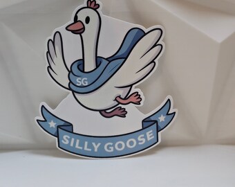 May include: A white goose wearing a blue scarf with the letters "SG" on it. The goose is flying with its wings spread out. The goose is on a blue banner with white stars and the text "Silly Goose".