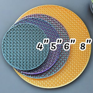 May include: Four round, yellow, orange, and blue placemats with a honeycomb pattern. The placemats are arranged in order of size, with the smallest placemat being 4 inches in diameter, the next largest being 5 inches, the next largest being 6 inches, and the largest being 8 inches.