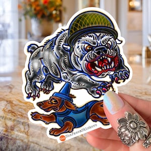 May include: A sticker featuring a bulldog wearing a green helmet and a dachshund in a blue outfit. The bulldog is gray with red accents, and the dachshund is brown. The sticker has a white border and the text "SharkasmStickers".