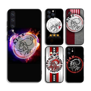 May include: Set of five phone cases featuring the Ajax Amsterdam logo. The cases are black with red and white accents. The logos feature a stylized head with a red and white design. The text "Ajax Amsterdam" is included on the logos.