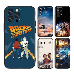 May include: A collection of five smartphone cases featuring Back to the Future movie imagery. Designs include the iconic logo with characters, the DeLorean car in various scenes, and character portraits, all displayed on dark and light backgrounds.