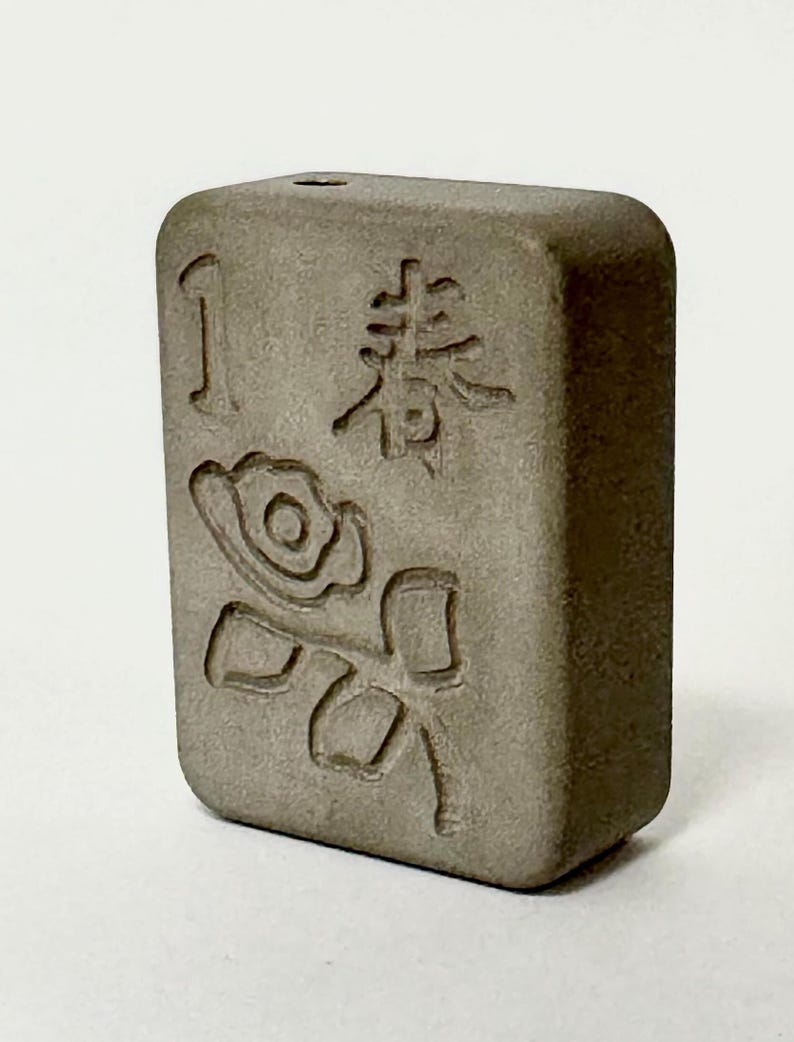 May include: A gray ceramic tile with a rose design and the number "1" and the Chinese character for "flower" on it.