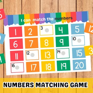 May include: A colorful educational game for kids to practice matching numbers. The game includes a board with numbers 1-20 and separate cards with numbers 3, 10, 12, 14, 16, and 3. The text on the board reads "I can match the numbers".