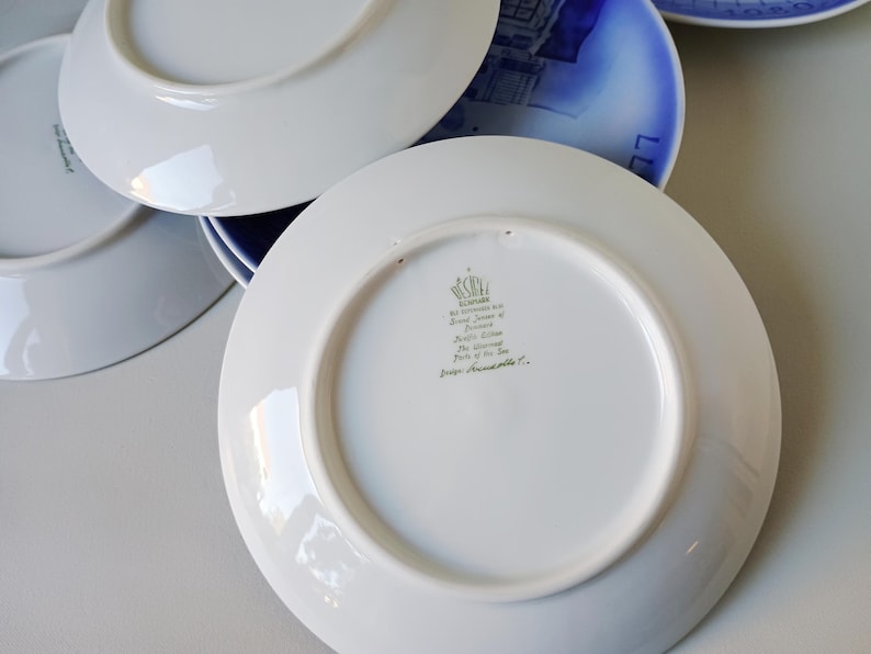 May include: White ceramic plate with a green and gold inscription that reads "The Unicorn, Prince of the Sea, from Franciscan Pottery Co."