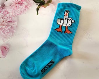 May include: A pair of turquoise blue socks with a white goose design giving the middle finger. The socks have the text "PONTY SOCKS" on the bottom.