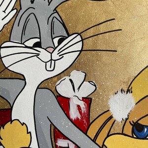 May include: A hand-painted canvas featuring Bugs Bunny and Tweety Bird. Bugs Bunny is wearing a gray suit and holding a red gift box. Tweety Bird is wearing a yellow dress and a white Santa hat. The background is gold with white speckles.