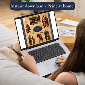 A lifestyle mockup showing a person sitting on a sofa using a laptop. The laptop screen displays the "Book of Ruth" clipart collection thumbnail, demonstrating the digital nature of the product. A blue banner at the top of the image reads "Instant download - Print at home!" to emphasize the convenience of the digital purchase. The setting is a bright, modern living room, suggesting ease of use for home projects or lesson planning.