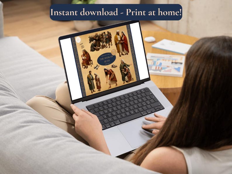 A lifestyle mockup showing a person sitting on a sofa using a laptop. The laptop screen displays the "Book of Ruth" clipart collection thumbnail, demonstrating the digital nature of the product. A blue banner at the top of the image reads "Instant download - Print at home!" to emphasize the convenience of the digital purchase. The setting is a bright, modern living room, suggesting ease of use for home projects or lesson planning.