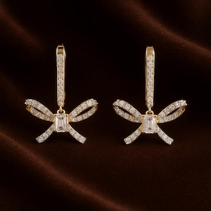Tiny Bow Drop Studs Earrings | Bow-Inspired Lab-Grown Diamond Earrings | Chic 14k Gold Bow Earrings with Sparkling Baguette Center Stone |