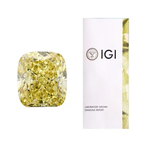 May include: A radiant, cushion-cut yellow diamond with a brilliant sparkle. The diamond is displayed next to a white document with the IGI logo and the text "LABORATORY GROWN DIAMOND REPORT".