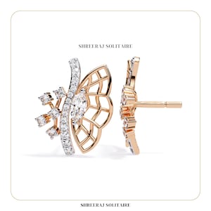 May include: A pair of gold butterfly-shaped earrings with a single diamond in each wing. The earrings have a delicate, intricate design and are set with sparkling diamonds.