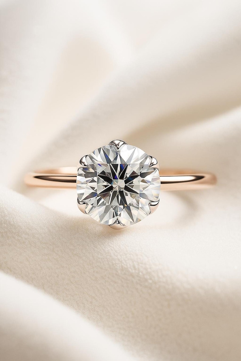 Top-down view of a 2 carat lab grown diamond engagement ring, round solitaire on a thin rose gold band.
