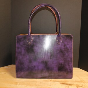 Purple tote bag with black lining