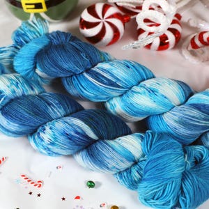 May include: A skein of blue and white yarn with a marbled effect. The yarn is soft and fluffy, and it would be perfect for knitting or crocheting a cozy winter scarf or hat.