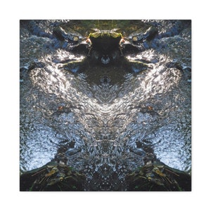 May include: A symmetrical photograph of a stream with sunlight reflecting off the water. The stream is surrounded by rocks and green foliage.