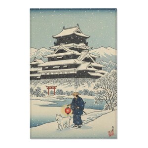 May include: A rectangular print depicting a Japanese winter scene. A figure in traditional attire walks with a dog along a snowy path, carrying a red lantern. A large castle and mountains are in the background.
