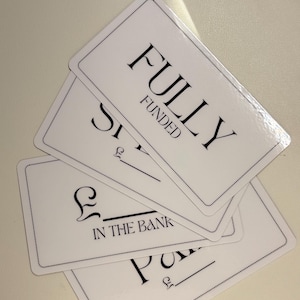 May include: Four white cards with black text. The top card says "FULLY FUNDED". The second card says "£ IN THE BANK". The third card says "£", and the fourth card says "£".