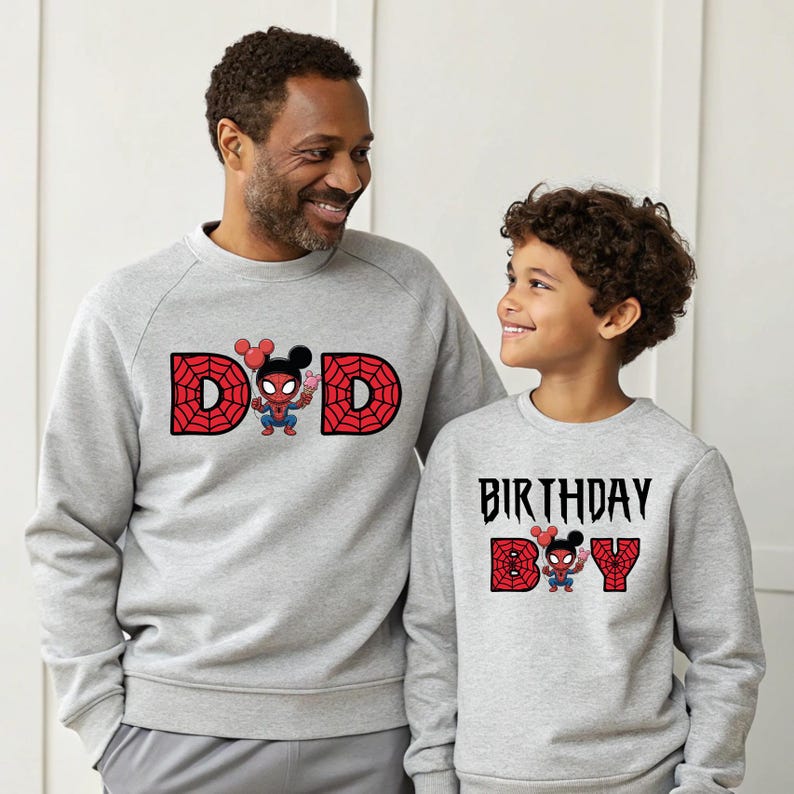 A man and a young boy wearing matching gray sweatshirts with Spider-Man and birthday text printed on them.