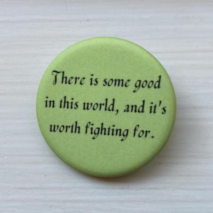 May include: A green button with the text "There is some good in this world, and it's worth fighting for."