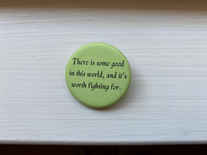May include: A green button with the text "There is some good in this world, and it's worth fighting for."