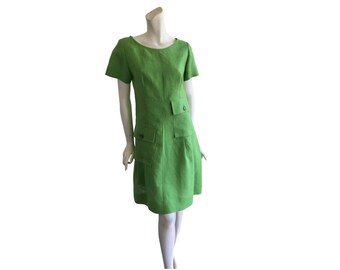 May include: A short-sleeved, lime green dress with a scoop neck and two large pockets on the front.