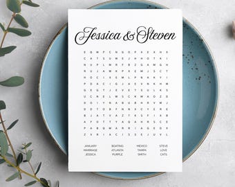 May include: A white paper with a word search puzzle, featuring the names "Jessica & Steven" in elegant script. The puzzle is on a blue plate, with greenery in the background. Keywords include "January", "Marriage", and "Jessica".
