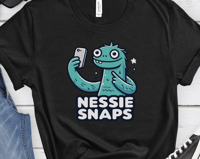 Nessie Snaps, Loch Ness Shirt, Cryptid Lover's Tee, Funny Cartoon Design, Unique Gift, Mythical Creature Shirt, Whimsical Shirt, Selfie Tee
